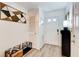 Stylish entryway with light wood floors, decorative bench, and white walls at 376 Eagle Tiff Dr, Sugar Hill, GA 30518