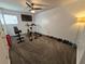 View of the home gym equipped with a treadmill, weights, stationary bike, and a ceiling fan at 376 Eagle Tiff Dr, Sugar Hill, GA 30518