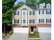 Charming townhome featuring a brick facade, black shutters, and attached two-car garage at 376 Eagle Tiff Dr, Sugar Hill, GA 30518