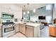 Bright kitchen features stainless steel appliances, granite countertops, and an open layout to the living room at 376 Eagle Tiff Dr, Sugar Hill, GA 30518