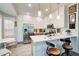 Well-appointed kitchen with a breakfast bar, stainless steel appliances, and white cabinetry at 376 Eagle Tiff Dr, Sugar Hill, GA 30518