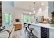 Open kitchen with breakfast bar, modern appliances, and abundant natural light at 376 Eagle Tiff Dr, Sugar Hill, GA 30518