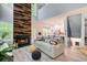 Bright and airy living room with fireplace, wood accent wall and open floor plan at 376 Eagle Tiff Dr, Sugar Hill, GA 30518