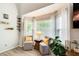 Cozy sitting area by the window with comfortable chairs, throw pillows, and shelves at 376 Eagle Tiff Dr, Sugar Hill, GA 30518