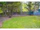 Large backyard featuring play equipment, including a dome climber and trampoline at 4015 Dodds Grove Ln, Alpharetta, GA 30009