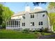 View of home's rear with spacious yard, screened porch and wooden deck at 4015 Dodds Grove Ln, Alpharetta, GA 30009