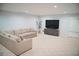 Finished basement with modern recessed lighting and a cozy sectional sofa at 4015 Dodds Grove Ln, Alpharetta, GA 30009