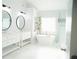 Bright bathroom featuring double vanity, freestanding tub, and modern fixtures, all in a clean, white aesthetic at 4015 Dodds Grove Ln, Alpharetta, GA 30009