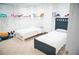 Bright bedroom featuring two twin beds, built-in shelving, and playful decor at 4015 Dodds Grove Ln, Alpharetta, GA 30009