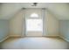 Bonus room featuring unique wallpaper, vaulted ceilings, light gray trim, and plenty of natural light at 4015 Dodds Grove Ln, Alpharetta, GA 30009