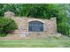 Stone sign for Danbury Park community, surrounded by lush landscaping at 4015 Dodds Grove Ln, Alpharetta, GA 30009