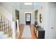 Elegant foyer with paneled walls, wood floors, and staircase with iron railings at 4015 Dodds Grove Ln, Alpharetta, GA 30009