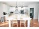 Bright kitchen features a marble island, stainless steel appliances, and white cabinetry for a modern aesthetic at 4015 Dodds Grove Ln, Alpharetta, GA 30009