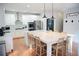 Well-lit kitchen boasts an expansive marble island, modern stainless appliances, and a stylish white backsplash at 4015 Dodds Grove Ln, Alpharetta, GA 30009