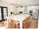 Spacious kitchen showcasing a large marble island with seating and stainless steel appliances at 4015 Dodds Grove Ln, Alpharetta, GA 30009