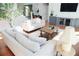 Open-concept living room with stylish furnishings, staircase, and natural light at 4015 Dodds Grove Ln, Alpharetta, GA 30009