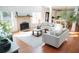 Cozy living room with brick fireplace, wood floors, and comfortable sofas at 4015 Dodds Grove Ln, Alpharetta, GA 30009