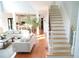 Bright and airy living room with hardwood floors, plush sofas, and an open floor plan flowing into the kitchen at 4015 Dodds Grove Ln, Alpharetta, GA 30009
