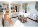 Open-concept living room with a fireplace, hardwood floors, and abundant natural light at 4015 Dodds Grove Ln, Alpharetta, GA 30009