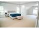 Spacious main bedroom with ample natural light, neutral tones, and a comfortable bed with a blue blanket at 4015 Dodds Grove Ln, Alpharetta, GA 30009