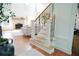Staircase with wooden steps and black iron spindles, opening to the living room at 4015 Dodds Grove Ln, Alpharetta, GA 30009
