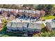 Aerial view of townhomes with mature trees and manicured landscaping at 5589 Trace Views Dr, Norcross, GA 30071
