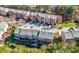 Aerial view of townhome community featuring mature trees and manicured lawns at 5589 Trace Views Dr, Norcross, GA 30071