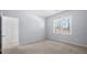 A brightly lit, empty bedroom featuring carpeted floors and a window at 5589 Trace Views Dr, Norcross, GA 30071