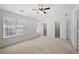Bedroom with neutral carpet, ceiling fan, and ensuite bathroom access provides a calming and serene space at 5589 Trace Views Dr, Norcross, GA 30071