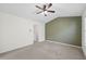 This carpeted bedroom has a ceiling fan, olive accent wall and provides entry to a separate bathroom at 5589 Trace Views Dr, Norcross, GA 30071