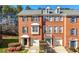 Inviting brick townhome showcasing manicured landscaping and an attached garage at 5589 Trace Views Dr, Norcross, GA 30071