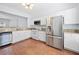 Modern kitchen with white cabinets, stainless steel appliances, and granite countertops at 5589 Trace Views Dr, Norcross, GA 30071