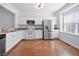 Modern kitchen with white cabinets, stainless steel appliances, and granite countertops at 5589 Trace Views Dr, Norcross, GA 30071