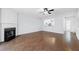 Bright living room with a fireplace, hardwood floors, and a ceiling fan at 5589 Trace Views Dr, Norcross, GA 30071
