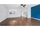Open-concept living space with hardwood floors, leading into a kitchen and stairway at 5589 Trace Views Dr, Norcross, GA 30071