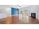 Bright living room with hardwood floors, fireplace, and large windows leading to deck at 5589 Trace Views Dr, Norcross, GA 30071