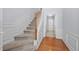 View of a home staircase featuring hardwood floors, carpeted stairs and detailed wall trim at 5589 Trace Views Dr, Norcross, GA 30071