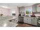 Bright kitchen with gray cabinets, granite countertops, and stainless steel appliances at 6547 Demere Dr, Morrow, GA 30260
