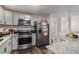 Modern kitchen with stainless steel appliances, granite countertops, and ample cabinet space at 6547 Demere Dr, Morrow, GA 30260