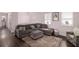 Cozy living room featuring a large sectional sofa, ottoman, and a patterned rug at 6547 Demere Dr, Morrow, GA 30260