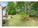 A spacious backyard with lush green grass, a patio, and mature trees at 1095 Athena Ct, Acworth, GA 30101