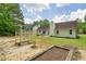 Wide view of the backyard showing a well-maintained lawn, patio, and wooden planter at 1095 Athena Ct, Acworth, GA 30101