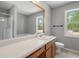 Bathroom featuring large mirror, ample counter space, natural light, and walk in shower at 1095 Athena Ct, Acworth, GA 30101