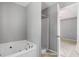 This bathroom features a large jacuzzi-style tub, a separate shower, and neutral gray walls at 1095 Athena Ct, Acworth, GA 30101
