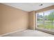 Bedroom features carpet, a large window overlooking a neighborhood, and neutral tan colored walls at 1095 Athena Ct, Acworth, GA 30101