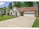 Exterior of the house showing the front yard, driveway, and two-car garage at 1095 Athena Ct, Acworth, GA 30101