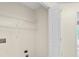 A laundry room features shelving, access to a closet, and a neutral color scheme at 1095 Athena Ct, Acworth, GA 30101