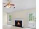 Inviting living room featuring a cozy fireplace, bright windows, and a ceiling fan at 1095 Athena Ct, Acworth, GA 30101