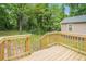 New wooden deck overlooking private backyard with mature trees and a house view at 1477 Olive Sw St, Atlanta, GA 30310
