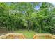 Large, private backyard with lush trees viewed from the new wooden deck at 1477 Olive Sw St, Atlanta, GA 30310